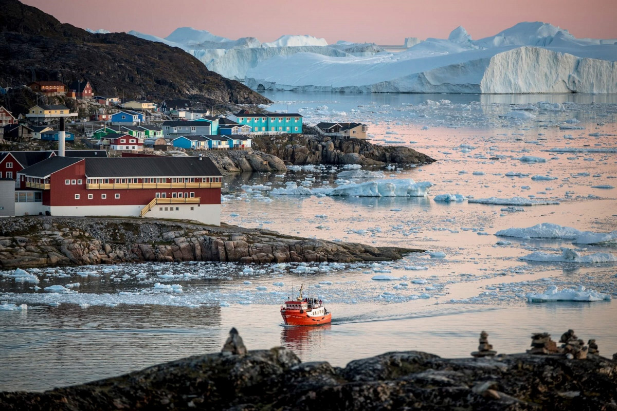 Ilulissat, town in North Greenland A passenger boat near Ilulissat and the ice fjord in Greenland